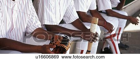 Baseball players sitting in dugout View Large Photo Image Stock Photo - Baseball players sitting in dugout. Fotosearch