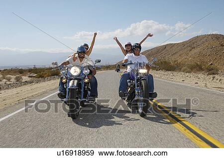 Stock Photo - Bikers riding on desert road. Fotosearch