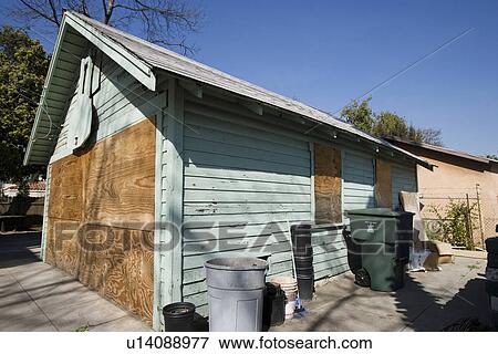 Stock Photo - Boarded Up Garage of Empty House. Fotosearch
