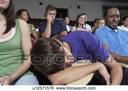 Bored students in lecture theatre during lesson View Large Photo Image Stock Photograph - Bored students in lecture theatre during lesson. Fotosearch