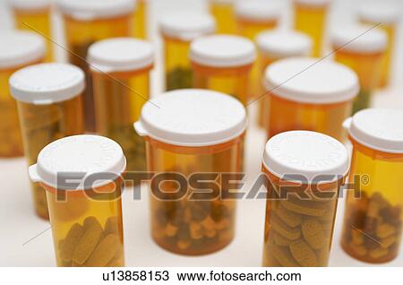 Stock Image - Bottles of pills, close-up. Fotosearch