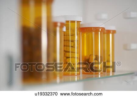 Bottles of pills in cabinet, close-up View Large Photo Image Stock Image - Bottles of pills in cabinet, close-up. Fotosearch