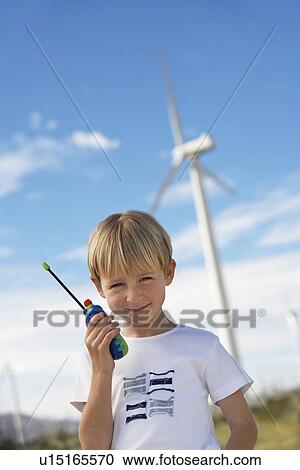 Boy (7-9) holding toy walky-talky at wind farm, portrait View Large Photo Image Stock Image - Boy (7-9) holding toy walky-talky at wind farm, portrait. Fotosearch