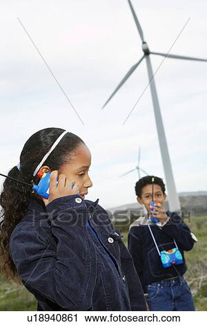 Boy and girl (7-9) playing with walky-talkies at wind farm View Large Photo Image Stock Image - Boy and girl (7-9) playing with walky-talkies at wind farm. Fotosearch