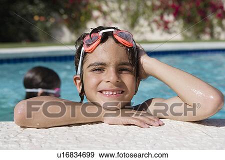 Stock Photo - Boy at Edge of Swimming Pool. Fotosearch