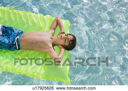 Boy Floating in Swimming Pool on Inflatable Mattress View Large Photo Image Stock Photograph - Boy Floating in Swimming Pool on Inflatable Mattress. Fotosearch
