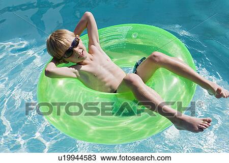 Boy on Float Tube in Swimming Pool View Large Photo Image Stock Image - Boy on Float Tube in Swimming Pool. Fotosearch