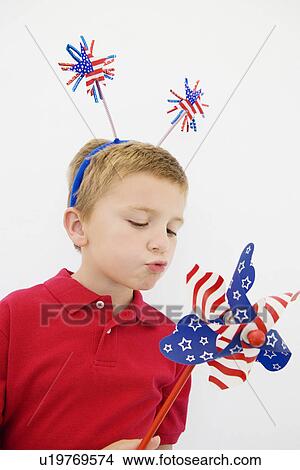 Picture - Boy Playing with Stars and Stripes Pinwheel. Fotosearch