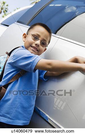 Stock Photo - Boy Standing by Minivan. Fotosearch