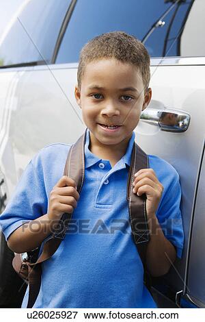 Stock Photo - Boy Standing by Minivan. Fotosearch