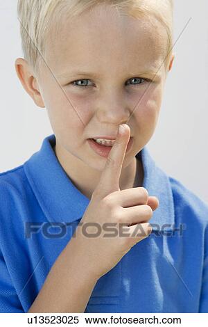 Stock Photography - Boy with Finger on Lips. Fotosearch