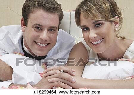 Bride and groom relaxing among presents, portrait, close-up View Large Photo Image Picture - Bride and groom relaxing among presents, portrait, close-up. Fotosearch