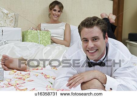 Bride and groom relaxing among presents, focus on groom View Large Photo Image Stock Image - Bride and groom relaxing among presents, focus on groom. Fotosearch