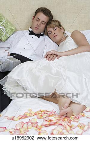 Bride and groom sleeping among presents View Large Photo Image Stock Image - Bride and groom sleeping among presents. Fotosearch