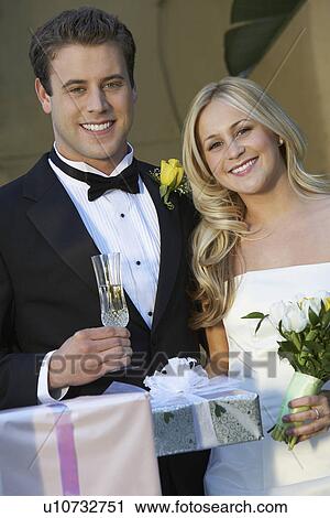 Stock Image - Bride and groom with wedding presents. Fotosearch
