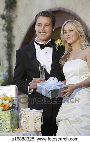 Stock Photo - Bride and groom with wedding presents. Fotosearch