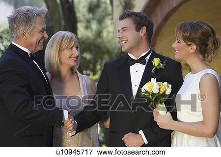 Bride, groom and parents exchanging wishes View Large Photo Image Stock Photo - Bride, groom and parents exchanging wishes. Fotosearch
