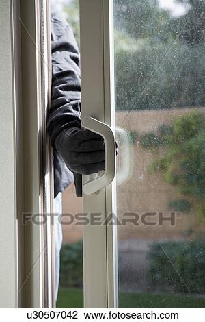 Burglar breaking into house, close-up of hand View Large Photo Image Stock Image - Burglar breaking into house, close-up of hand. Fotosearch