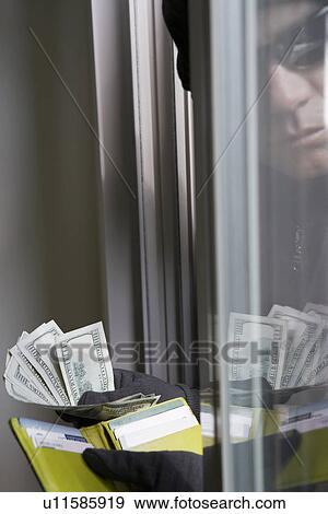 Burglar stealing money, close-up View Large Photo Image Stock Photo - Burglar stealing money, close-up. Fotosearch