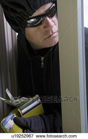 Burglar stealing money, close-up View Large Photo Image Stock Photo - Burglar stealing money, close-up. Fotosearch