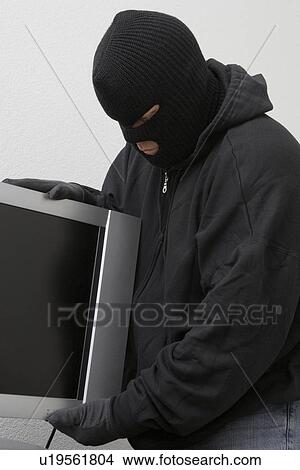 Picture - Burglar stealing television set. Fotosearch