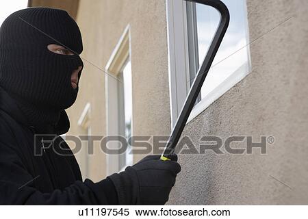 Burglar using crowbar to break into house View Large Photo Image Stock Photography - Burglar using crowbar to break into house. Fotosearch