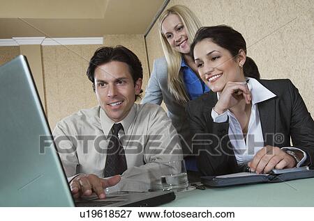 Business man and woman using laptop at conference meeting View Large Photo Image Stock Photo - Business man and woman using laptop at conference meeting. Fotosearch