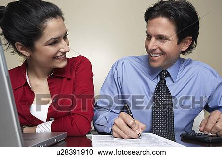 Business man and woman working in office View Large Photo Image Stock Image - Business man and woman working in office. Fotosearch