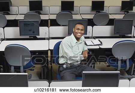 Business man sitting in classroom, elevated view, portrait View Large Photo Image Stock Image - Business man sitting in classroom, elevated view, portrait. Fotosearch