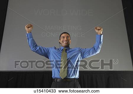 Business man speaking at conference, arms raised View Large Photo Image Stock Image - Business man speaking at conference, arms raised. Fotosearch