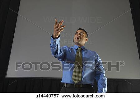 Business man speaking at conference, pointing View Large Photo Image Stock Photo - Business man speaking at conference, pointing. Fotosearch
