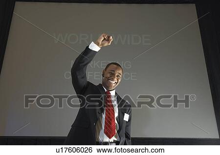 Business man speaking at conference, arm raised View Large Photo Image Stock Photograph - Business man speaking at conference, arm raised. Fotosearch