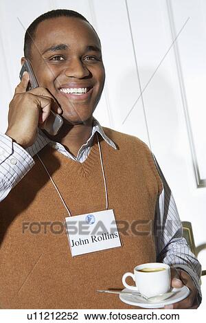 Business man using mobile phone in office, portrait View Large Photo Image Stock Image - Business man using mobile phone in office, portrait. Fotosearch
