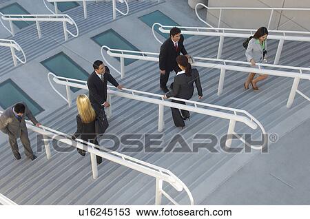 Business people moving up and down stairs, elevated view View Large Photo Image Stock Image - Business people moving up and down stairs, elevated view. Fotosearch