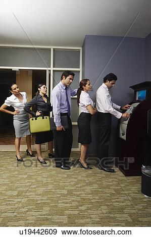 Business people queuing at vending machine View Large Photo Image Stock Photo - Business people queuing at vending machine. Fotosearch