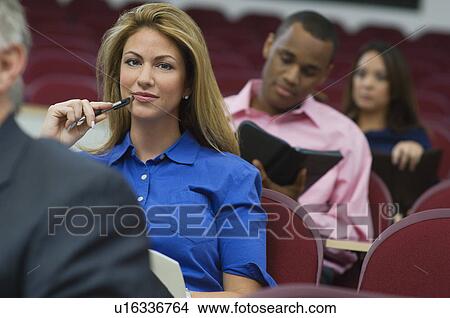 Picture - Business people sitting in auditorium. Fotosearch