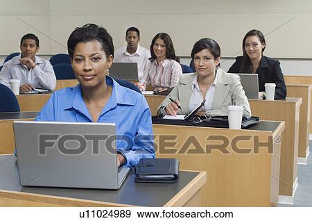 Business people sitting in classroom View Large Photo Image Stock Photo - Business people sitting in classroom. Fotosearch