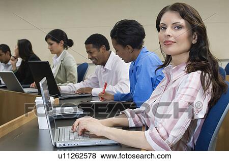 Stock Photo - Business people sitting in classroom. Fotosearch