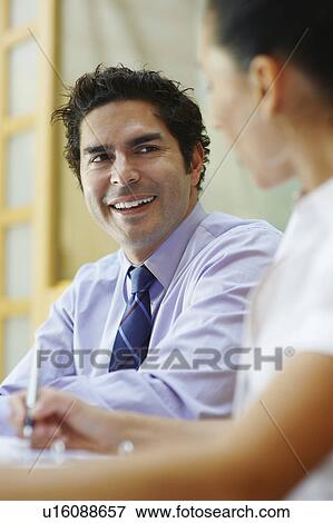 Stock Photo - Business people sitting in meeting. Fotosearch