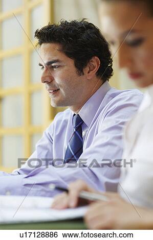 Stock Photograph - Business people sitting in meeting. Fotosearch