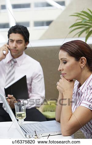 Stock Image - Business woman and business man working in office. Fotosearch
