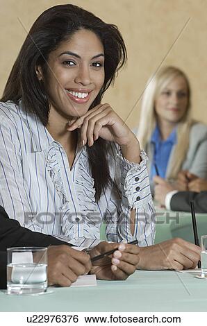 Stock Photograph - Business woman at conference meeting, portrait. Fotosearch