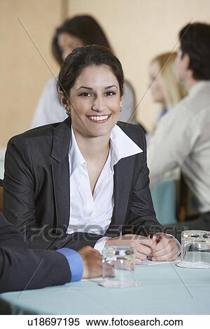 Stock Photography - Business woman smiling in conference, portrait. Fotosearch