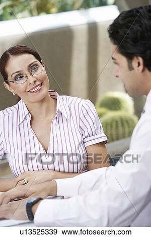 Business woman talking to colleague View Large Photo Image Stock Photo - Business woman talking to colleague. Fotosearch