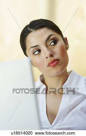 Stock Image - Business woman using laptop in office. Fotosearch