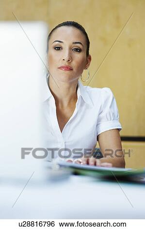 Stock Photograph - Business woman using laptop in office. Fotosearch