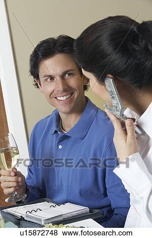 Business woman using mobile phone with male colleague in restaurant View Large Photo Image Stock Photo - Business woman using mobile phone with male colleague in restaurant. Fotosearch