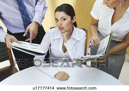 Picture - Business woman working with colleagues in office. Fotosearch