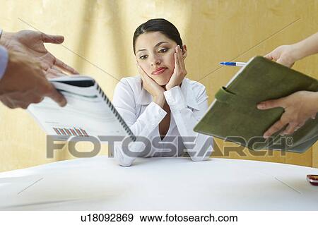 Stock Photo - Business woman working with colleagues in office. Fotosearch