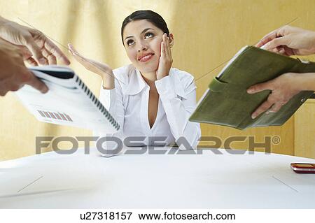 Stock Photo - Business woman working with colleagues in office. Fotosearch
